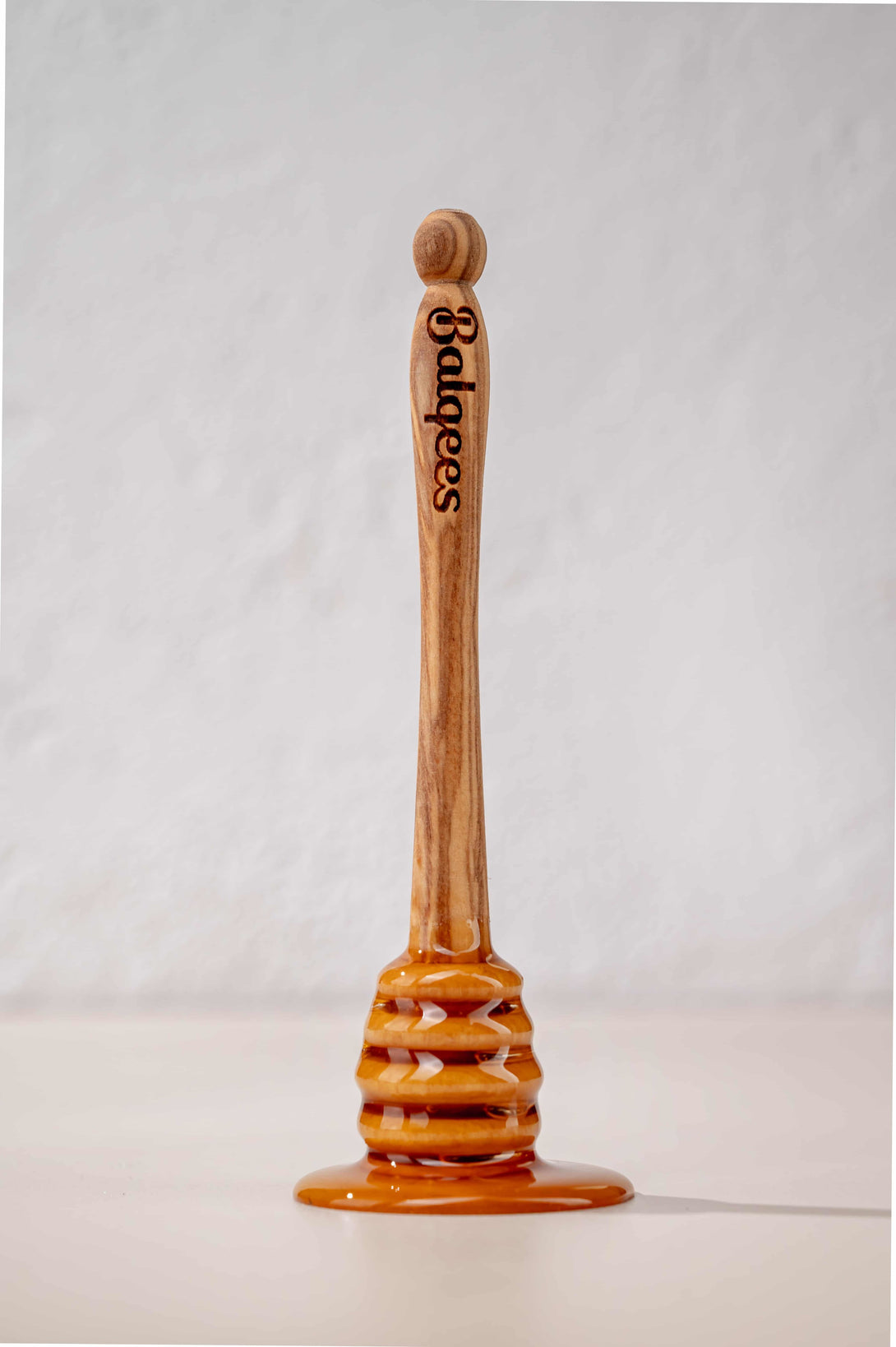 Balqees Engraved Olive Wood Drizzler dripping in honey